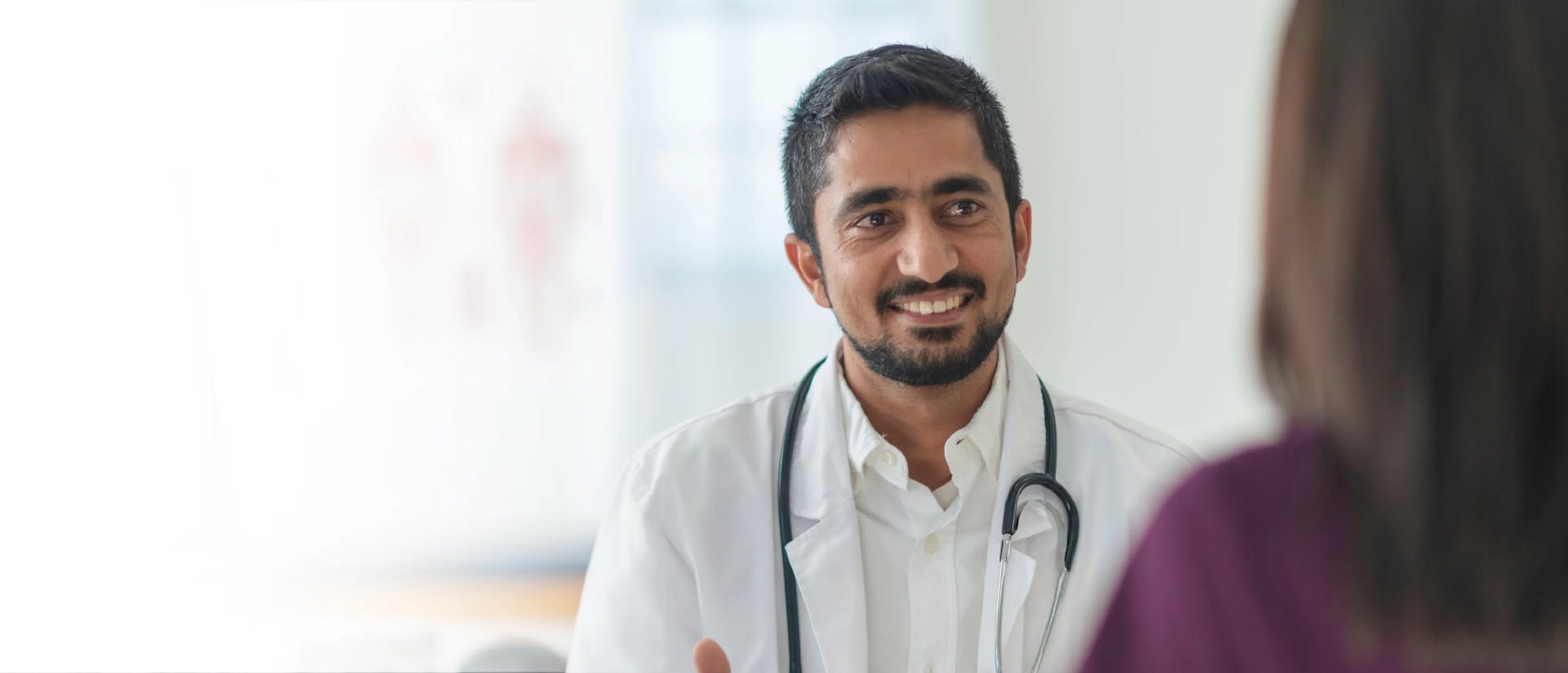 Image of a doctor looking at a patient